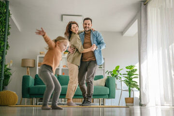 Family enjoying dancing and celebrating happiness at home