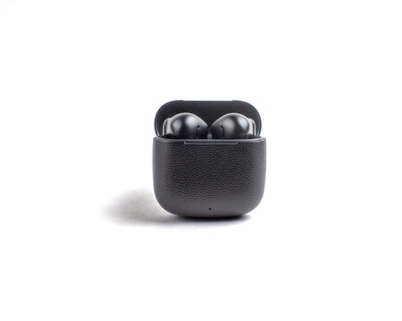 Black wireless earbuds in an open charging case, with the brand name visible