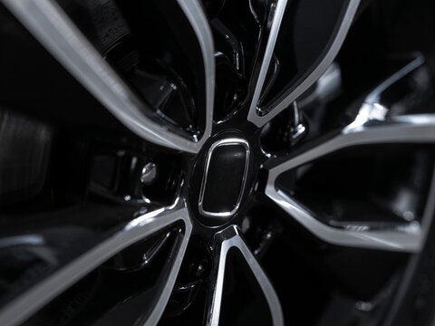 Close-up of modern car alloy wheel with black and silver design, automotive detail photography