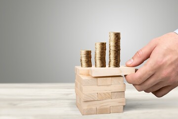 Stack coins on wood tower cubes, business risk