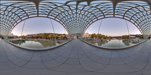 Naklejka premium spherical hdri panorama 360 degrees. Spherical aerial view on glass and steel frame and concrete construction pedestrian bridge.