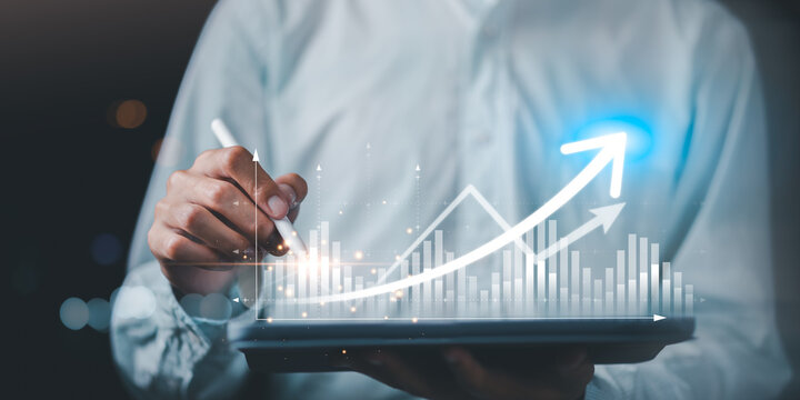Digital growth analytics concept with hands using tablet, data visualization, bar charts, upward arrow. Represents performance improvement, strategic planning, data driven insight, scalability