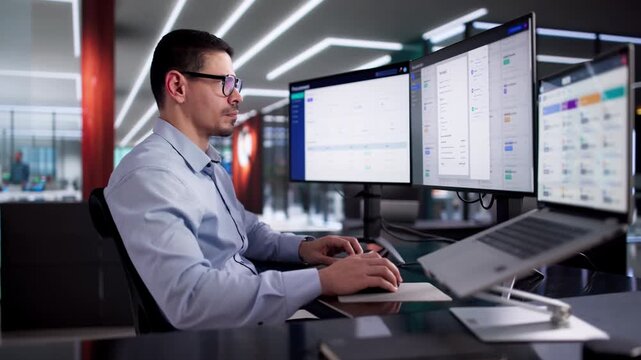 Man Using Online Document Management Software To Store Contracts