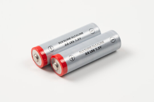 AA alkaline LR6 1.5V batteries isolated on white background, themes of portable power, energy, and electronic accessories.