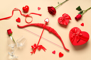Naklejka premium Composition with cupid's bow, gift boxes, rose flowers and glasses on color background. Valentine's Day celebration