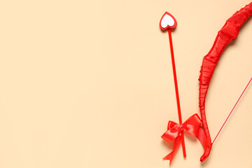 Naklejka premium Red cupid's bow on color background. Valentine's Day celebration