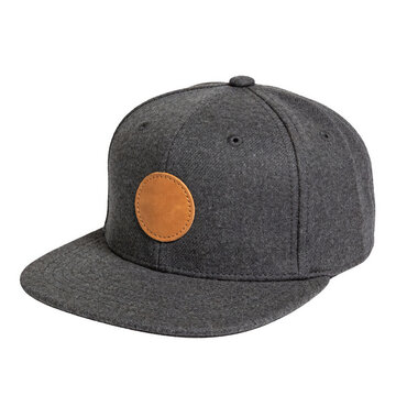 Gray flat brim cap with a tan leather circular patch, isolated on white. Designed for fashion and casual wear, featuring a structured fit and minimalist aesthetic.
