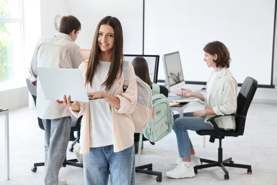 Female student studying with laptop at school computer lab