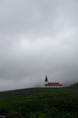 Historic church or chapel with tower at sunset in European countryside landscape © Xavi