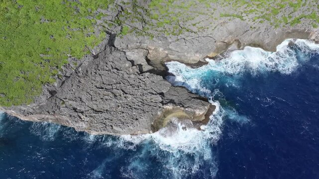 Witness the powerful convergence of history and nature. This dramatic drone footage captures the rugged northern coastline of Saipan, featuring the towering Banzai Cliff and Suicide Cliff. The deep bl