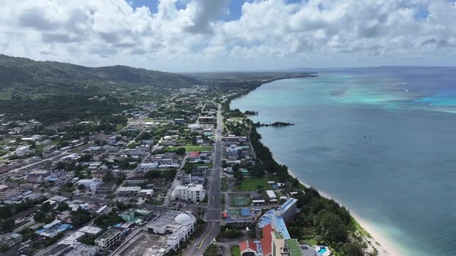 Trace the path of endurance in paradise. This sweeping aerial footage captures the renowned coastal running course along Saipan's west coast, famous for hosting international marathons. Stretching fro