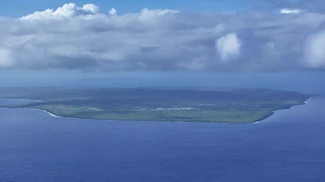 "A sweeping aerial view looking south from the beautiful west coast of Saipan toward Tinian Island. The deep blue Saipan Channel and turquoise lagoon provide a stunning backdrop for travel and nature