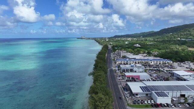 Trace the path of endurance in paradise. This sweeping aerial footage captures the renowned coastal running course along Saipan's west coast, famous for hosting international marathons. Stretching fro