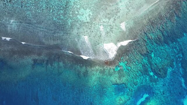 "A stunning aerial drone shot capturing the calm and crystal-clear emerald waters of Saipan&rsquo;s west coast. Features beautiful coral reefs visible through the transparent sea."