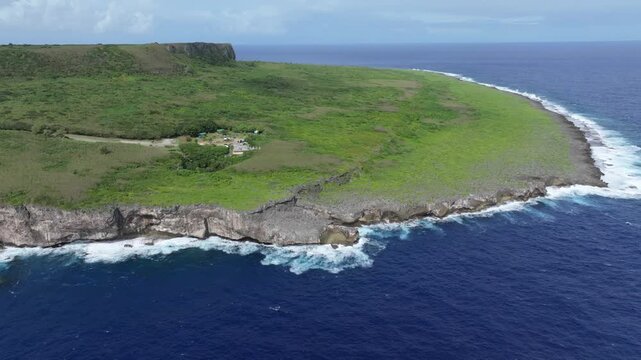 Witness the powerful convergence of history and nature. This dramatic drone footage captures the rugged northern coastline of Saipan, featuring the towering Banzai Cliff and Suicide Cliff. The deep bl