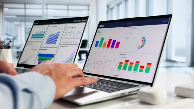 Financial Analyst At Desk With Computer Dashboard