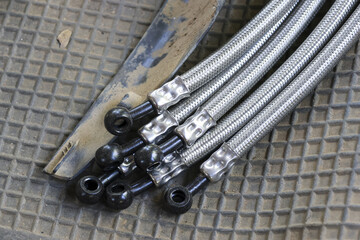 Close up of stainless steel braided brake lines, high performance automotive part for custom car...