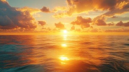 Obraz premium A captivating golden sunset casts its magnificent glow across the tranquil ocean, with vibrant clouds reflecting the sun's warm light on the shimmering water, creating a serene natural beauty