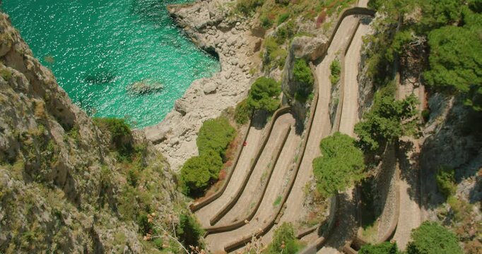 Scenic coastal cliffs and Via Krupp path with turquoise sea water seen from a high rocky viewpoint on Capri Island Italy