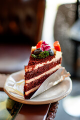 A beautiful blueberry and strawberry cake topped with lemonade, served on a plate, with a cafe as the backdrop.