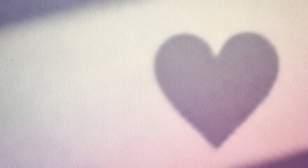 A blurred heart shape centered on a soft pastel background from a close-up viewpoint