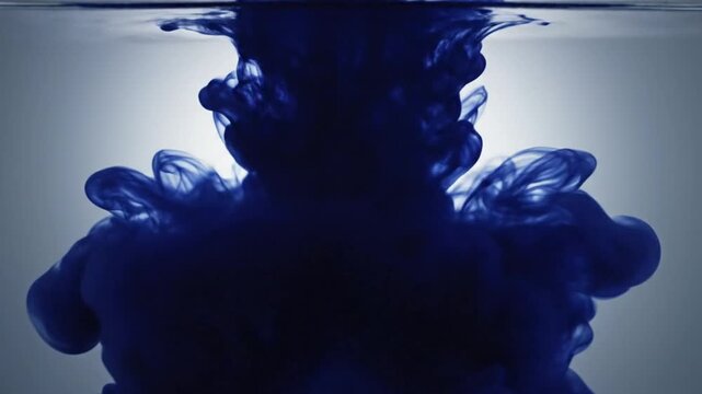 Blue Ink Droplet Spreading Through Clear Water.