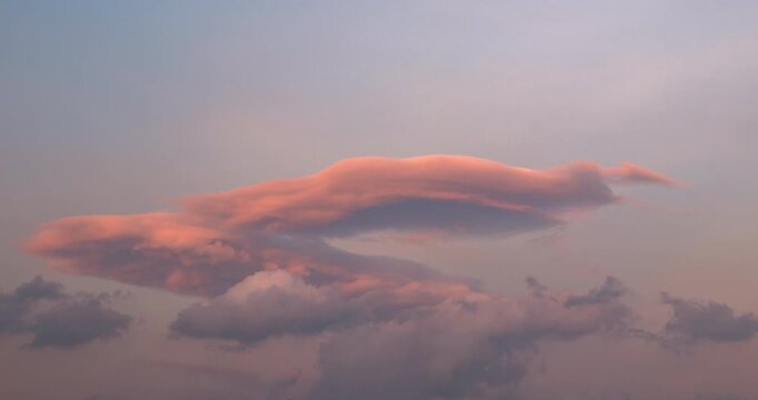 Timelapse of lenticular clouds hovering in the sky during sunset