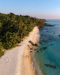 Takhian beach koh kood thailand at sunset with crystal clear waters and lush greenery