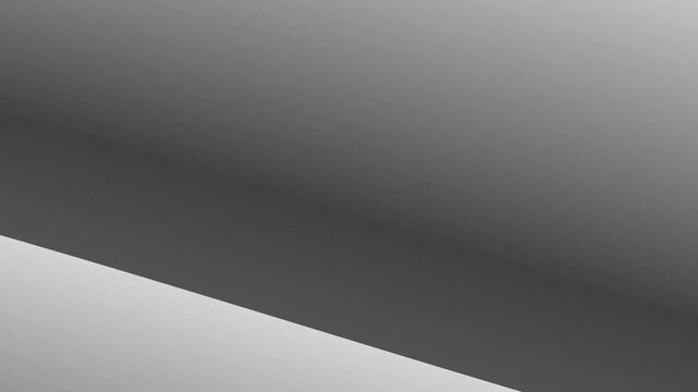 Abstract grey gradient background with a sharp diagonal line separating two distinct shades of grey, creating a modern and minimalist design.