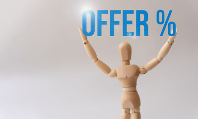 wooden mannequin holding the words "Offer %"