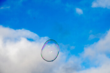 Soap bubble floating in sky near Lisbon waterfront buildings