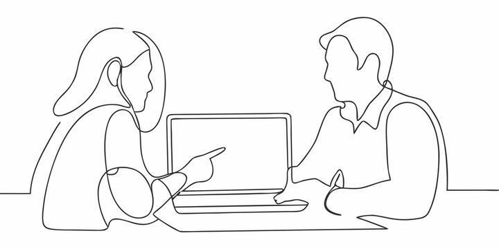 Two people discussing work while looking at a laptop computer