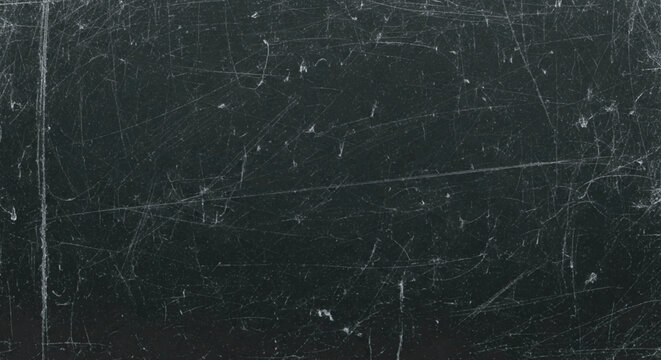 Dark, textured surface with numerous scratches and light imperfections.