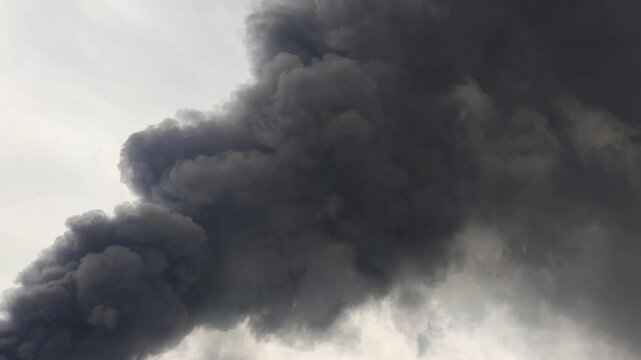 Thick Dark Smoke Billowing From Intensive Industrial Fire