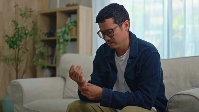 Asian Man Suffering from Wrist Pain
