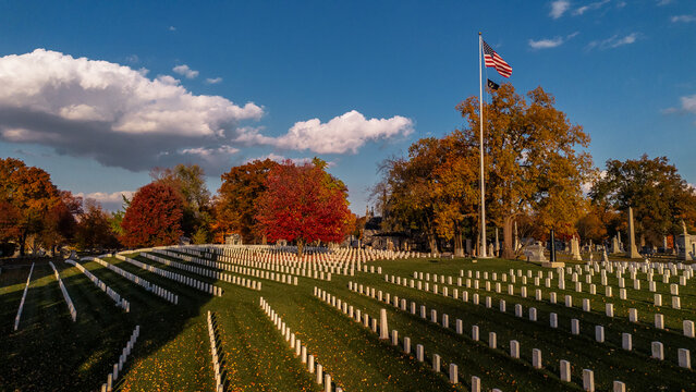 An aerial view of a veteran soldier graves on a hill in a Midwest cemetery