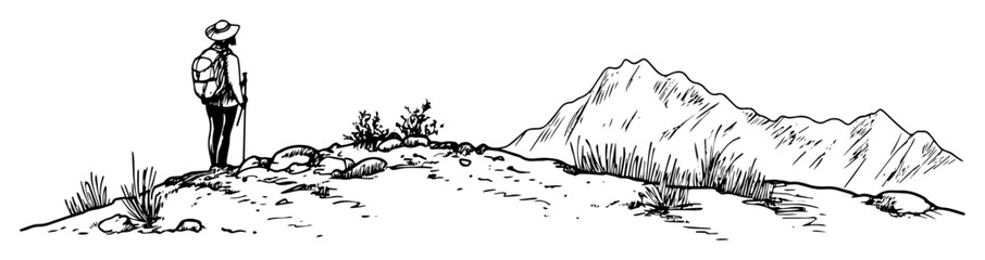 hiker standing on rocky hill with mountain view