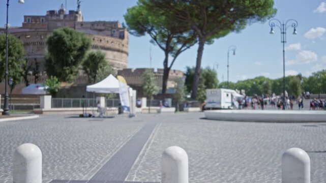 Blurred outdoor plaza scene in rome with shallow bokeh and cobblestone foreground; background, backplate, copyspace, calm.