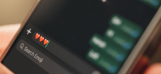 Phone screen, chat or message with heart emoji for virtual dating, romantic relationship or...