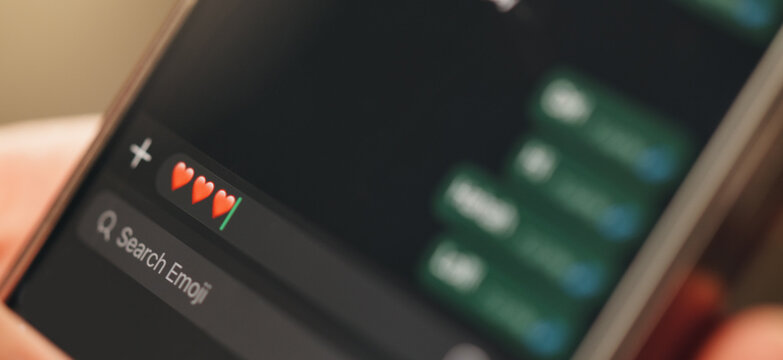 Phone screen, chat or message with heart emoji for virtual dating, romantic relationship or connection. Online conversation, partner response or mobile with icon for digital romance, love and closeup