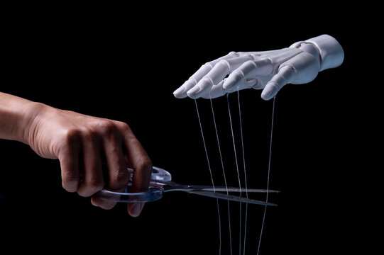 Human Hand Cutting Strings of Robotic Puppet Master for Freedom Concept