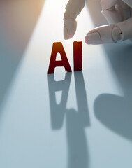 Robotic Hand Pointing at Red AI Letters with Dramatic Light and Shadow