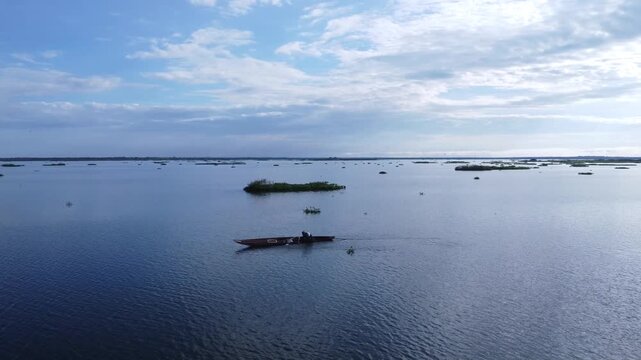 Man Rowing a Canoe on River in Mompox Colombia