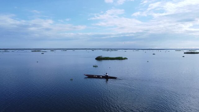 Man Rowing a Canoe on River in Mompox Colombia