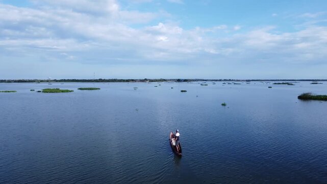 Man Rowing a Canoe on River in Mompox Colombia