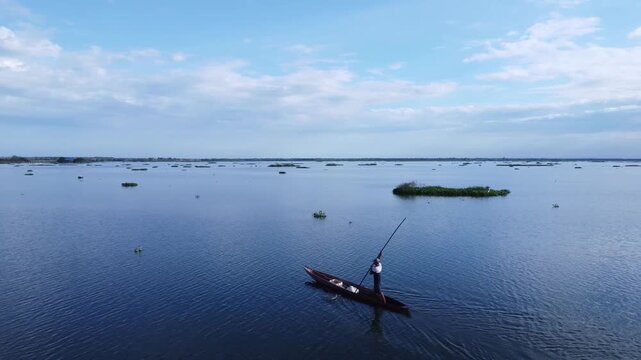 Man Rowing a Canoe on River in Mompox Colombia