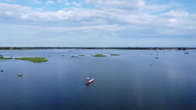 Man Rowing a Canoe on River in Mompox Colombia