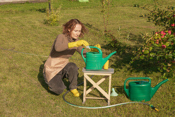 woman fertilizing apple tree