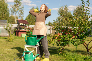 woman fertilizing apple tree