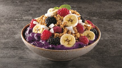 Fototapeta premium Vibrant Brazilian acai bowl topped with fruits and granola: A colorful acai bowl filled with a deep purple smoothie base, topped with fresh berries, banana slices, granola, and coconut flakes, served